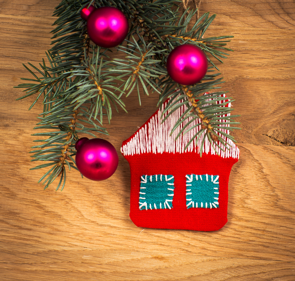 Christmas house with fir paws and ornaments